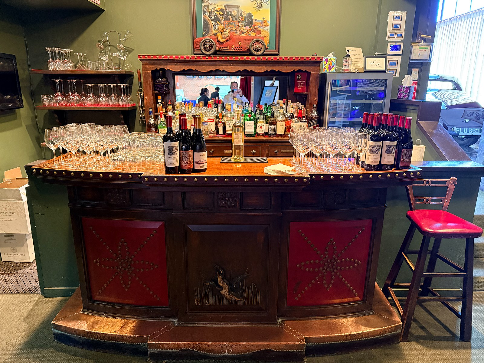 The antique bar set with glassware and bottles