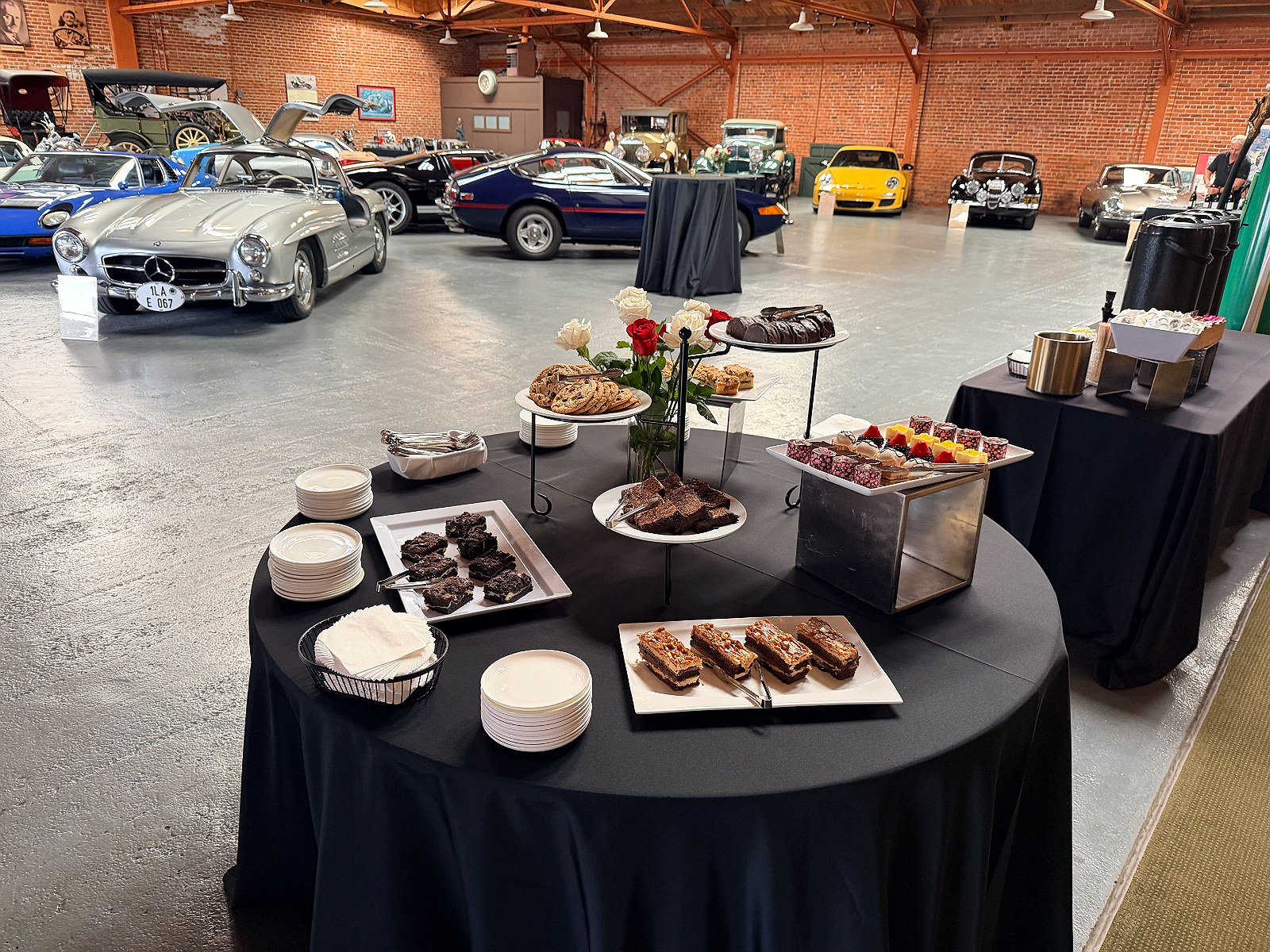 A dessert table among the cars